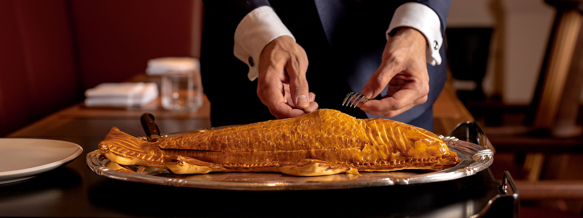 Sea bass en croute for two people served at the table in The Connaught Grill restaurant at The Connaught in Mayfair